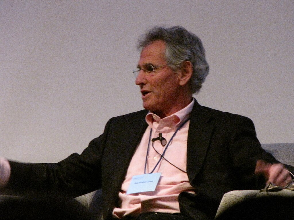 Porträt Jon Kabat Zinn, er hat ein Namensschild um den Hals hängen.
